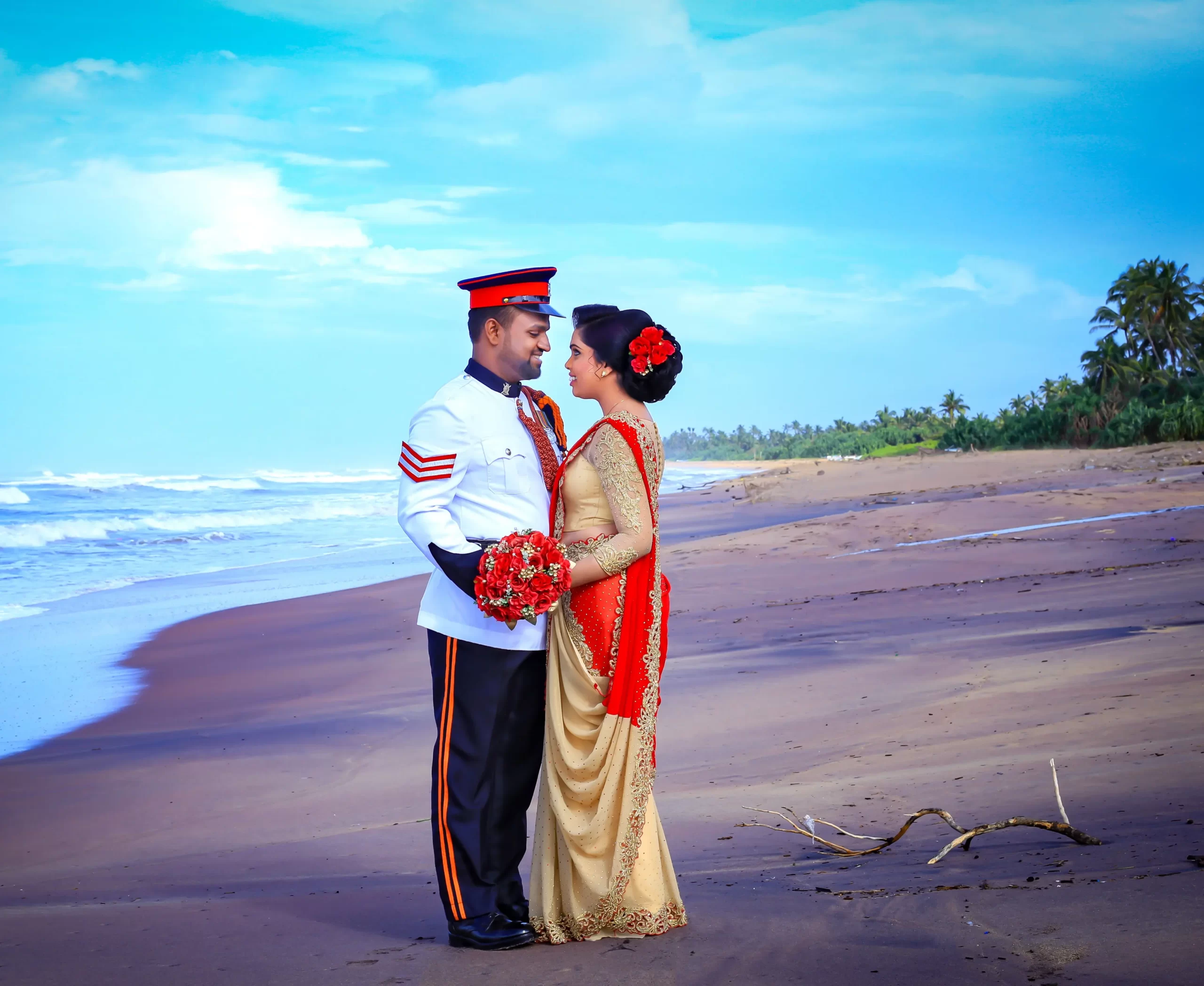 Bride and groom holding hands with beach sunset