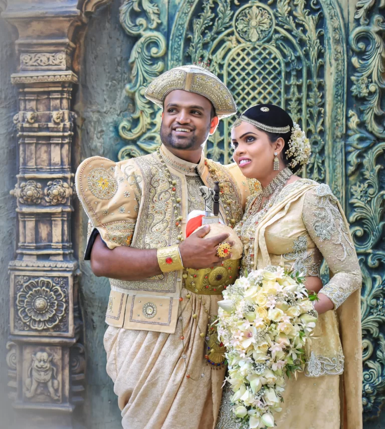 Captivating moment as a Sri Lankan traditional couple in wedding attire share a gaze outdoors.