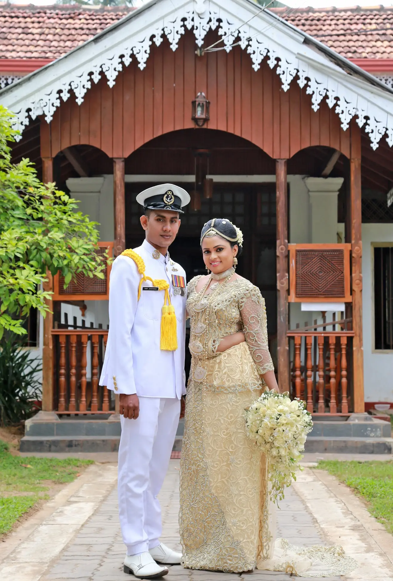 Couple standing on a bridge surrounded by greenery