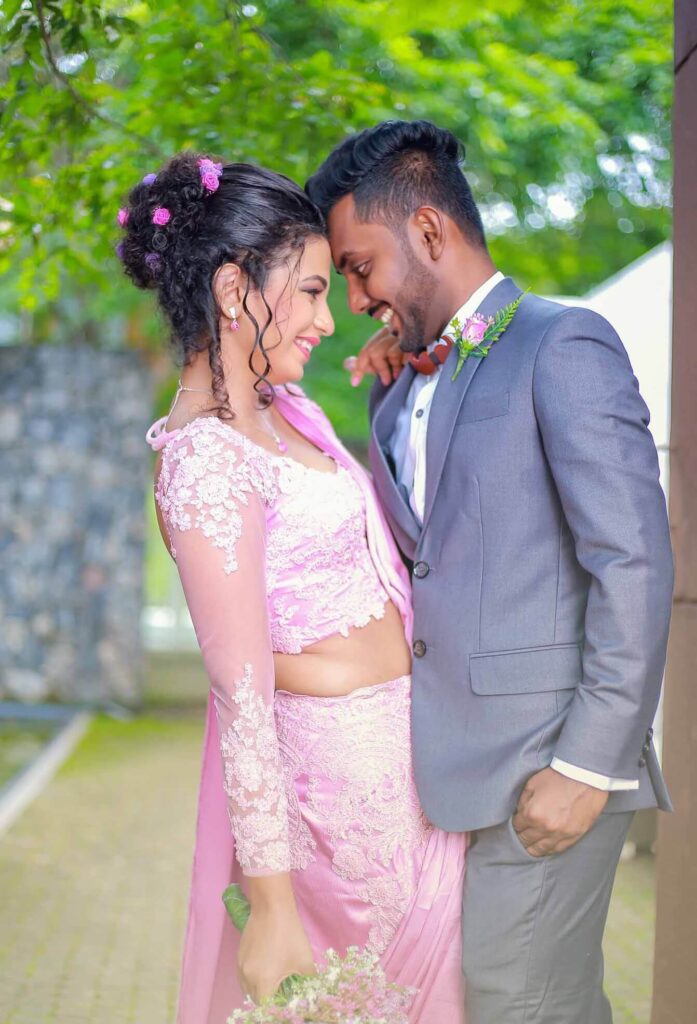 Pre-wedding shoot of a smiling wedding couple facing each other.