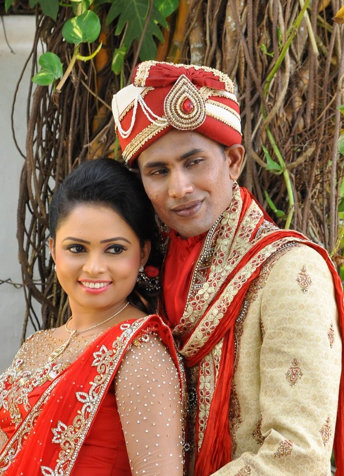 Indian-inspired elegance: Sri Lankan couple, the girl in a resplendent red saree.