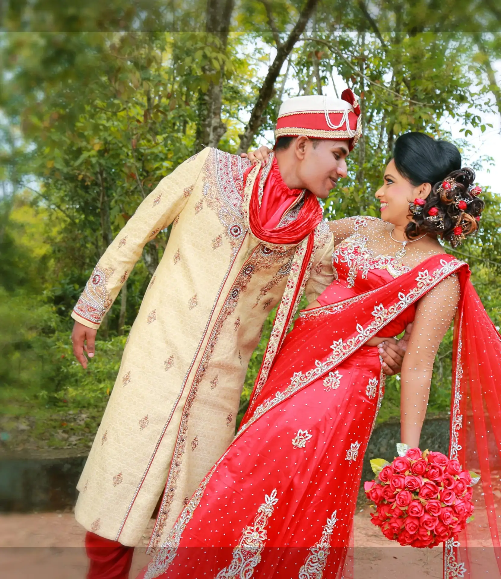 Indian fashion influence: Sri Lankan couple, girl draped in a mesmerizing red saree.