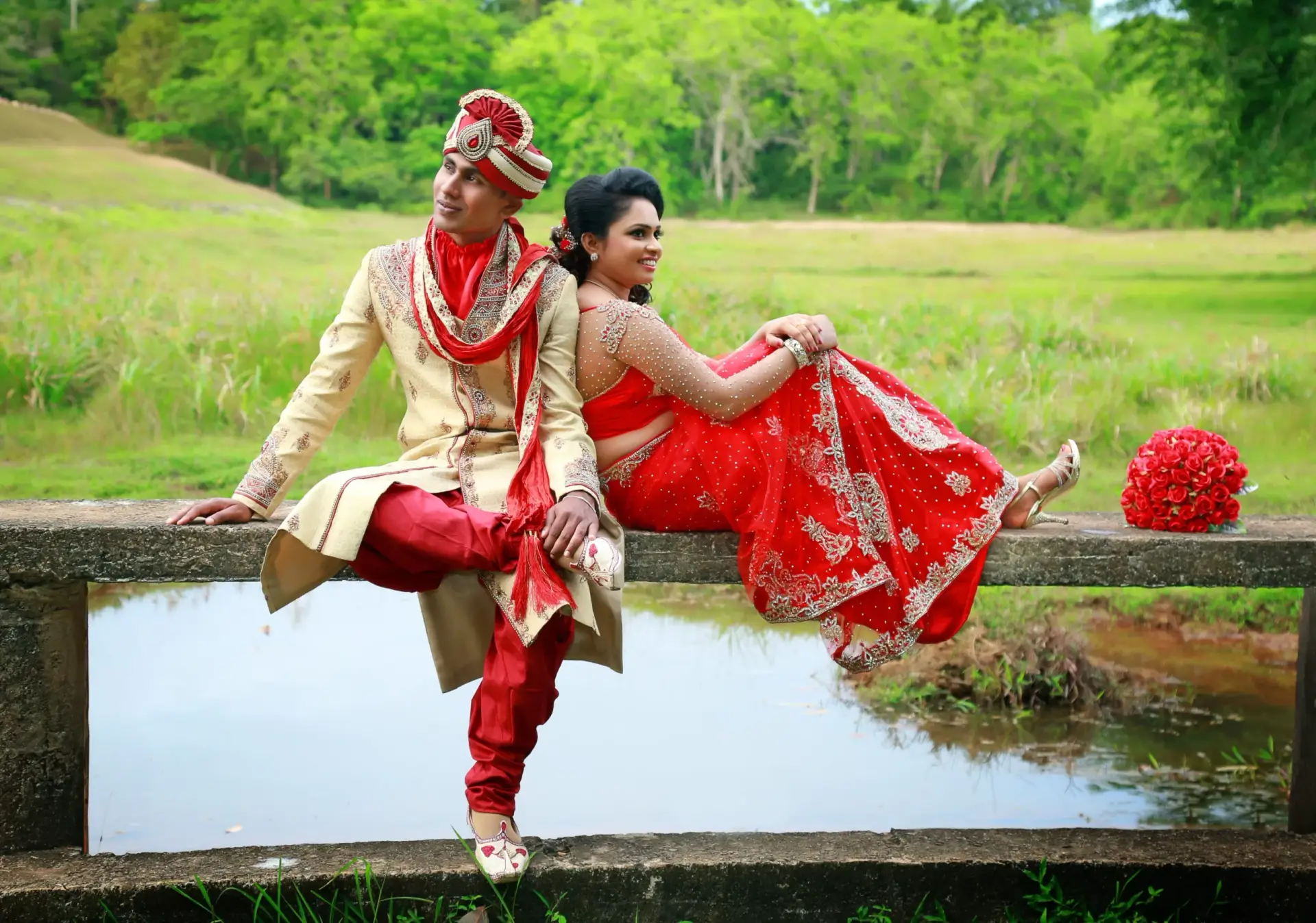 Cultural fusion: Sri Lankan couple in Indian-style wedding attire, girl in a stunning red saree.