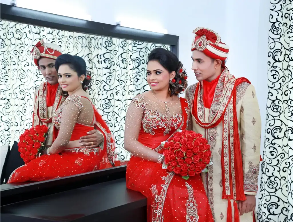 Indian-inspired Sri Lankan couple, girl elegantly dressed in red saree.