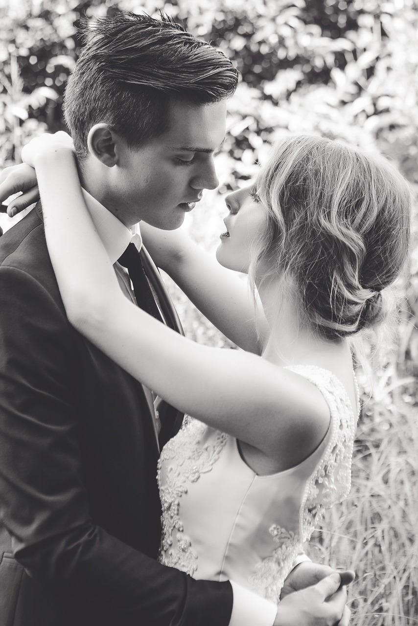 Artistic image of a wedding couple embracing.