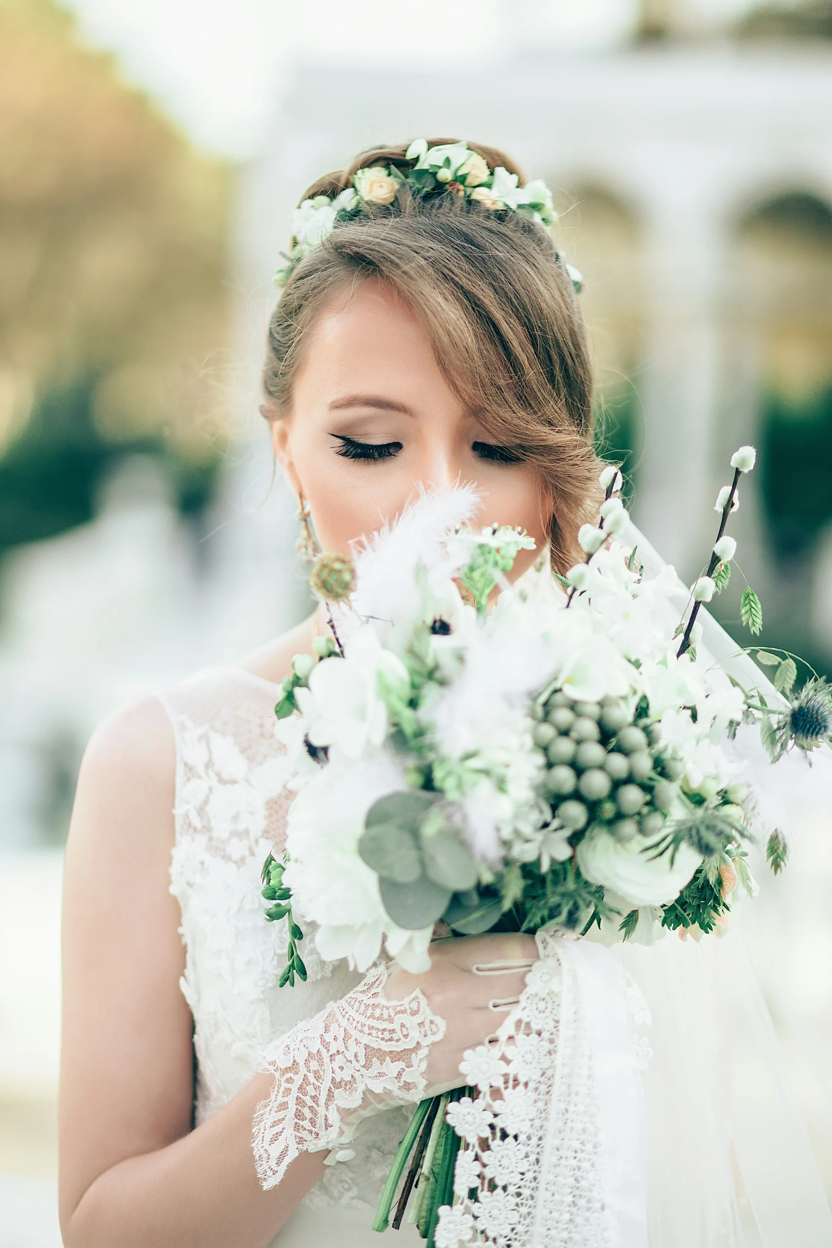 A bride holding a lavish bouquet of colorful flowers, radiating joy and beauty.