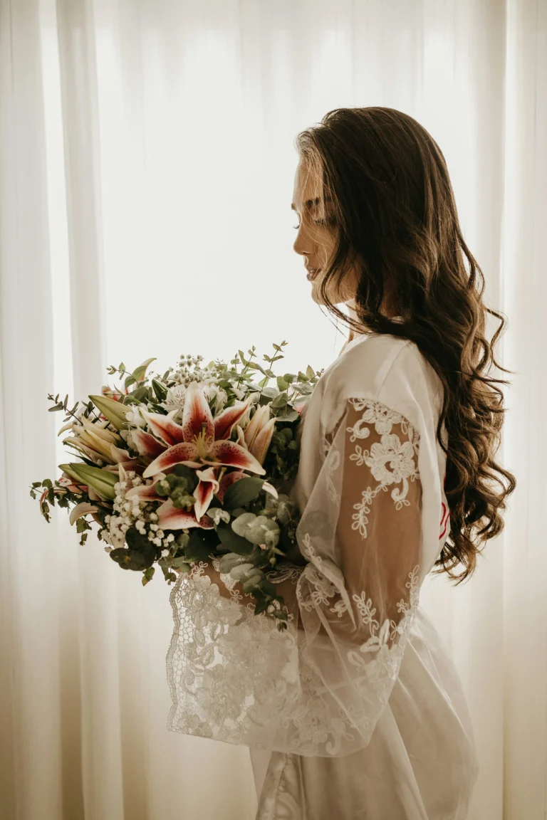 Portrait of a radiant bride holding a bouquet of flowers, her elegance and beauty shining through.