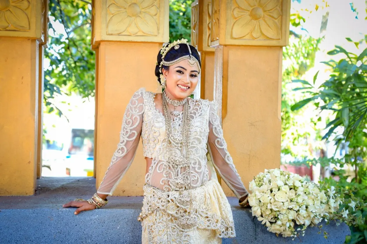 Bride holding her bouquet while gazing into the distance.